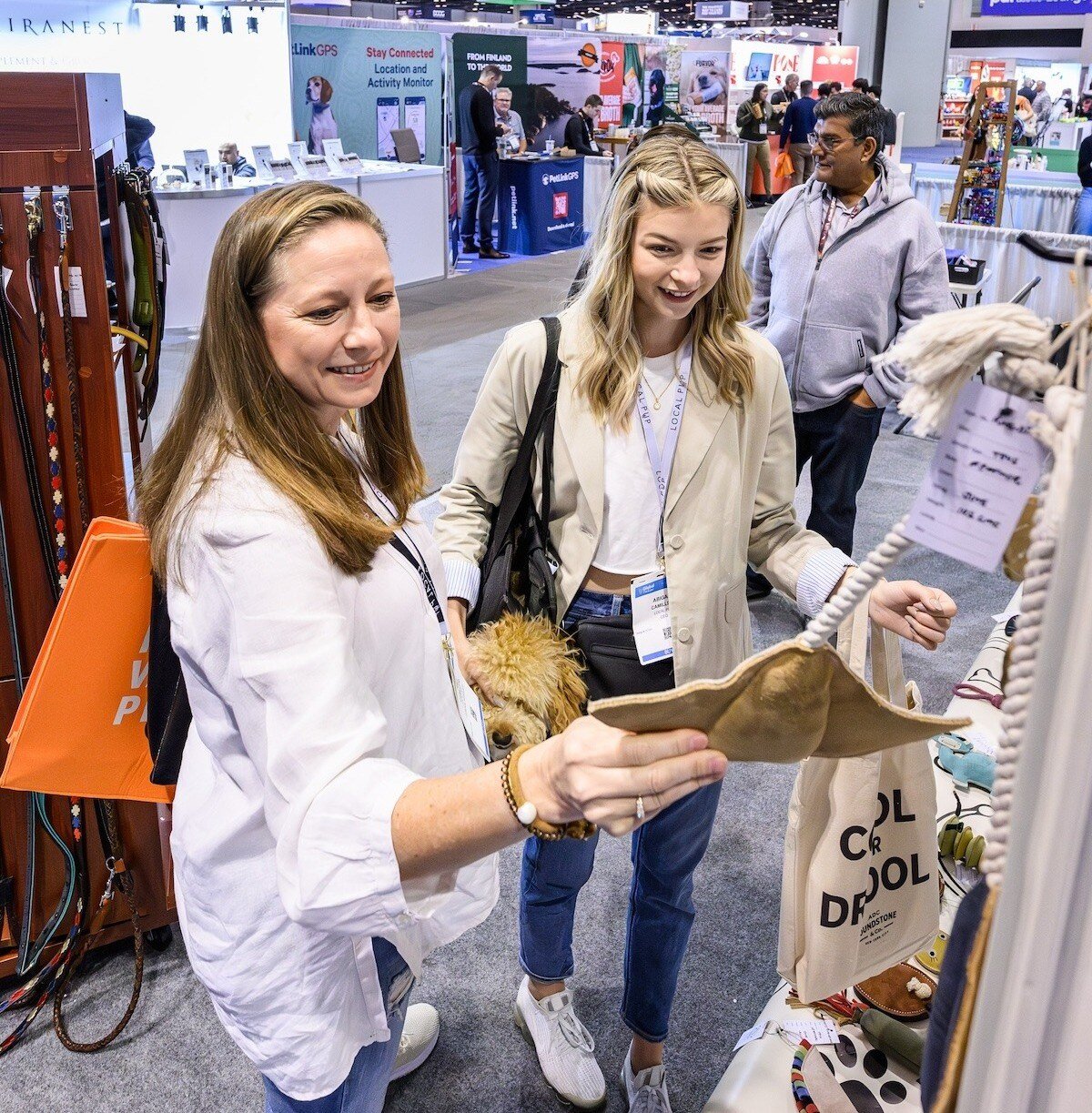 Two Women Retail Buyers Looking at Dog Toys and Smiling
